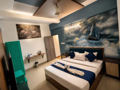 a bedroom with a bed with a painting on the wall at Levora Suits in Kottayam