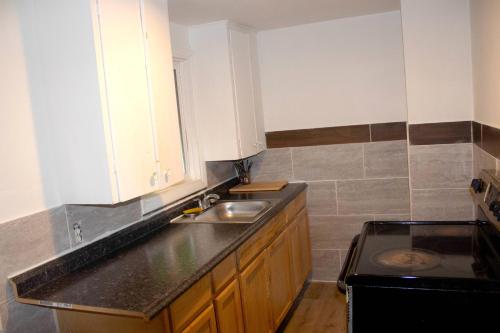 a kitchen with a sink and a stove at Stevenson Motel Federal Way near I 5 in Federal Way