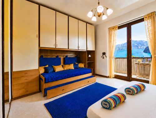 a bedroom with two beds and a large window at Happy Guest Apartments - Lake Panorama & Pool in Riva di Solto