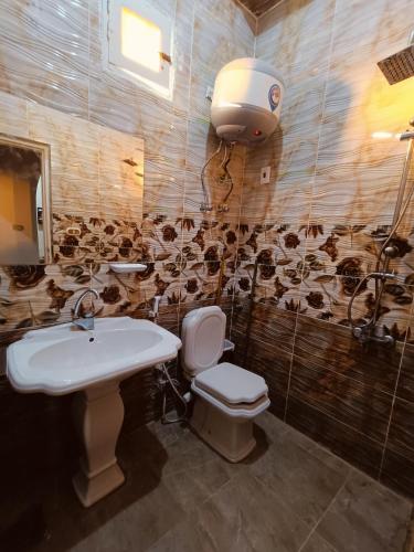 a bathroom with a sink and a toilet at Dar Alsalam Suites in Siwa