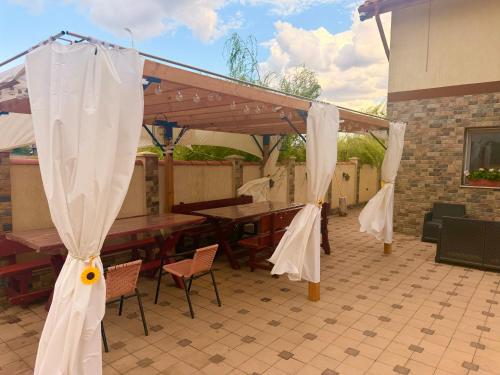 a pavilion with white drapes on a patio at Nistor House-Delta Retreat in Tulcea