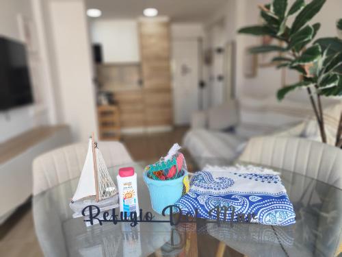 a glass table with a towel and a bag on it at Refugio del Mar Primera linea a estrenar in Algarrobo-Costa