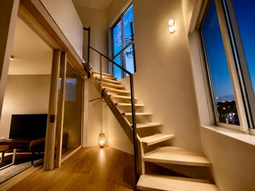 a staircase in a house with large windows at Villa Monica EAST in Nagoya