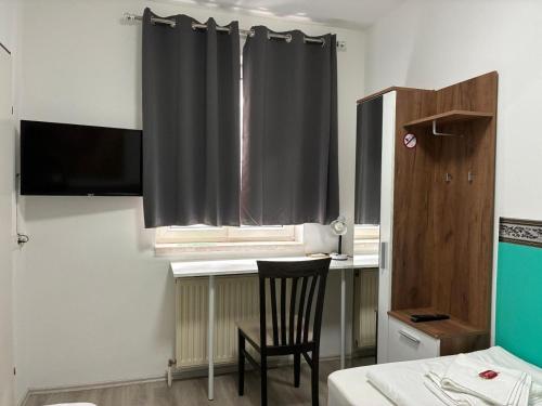 a room with a table and a chair and a window at Mariazellerhof Room 015 in Sankt Pölten