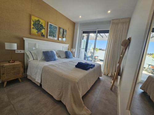 a bedroom with a bed with a view of the ocean at Marina Serena in La Cala de Mijas