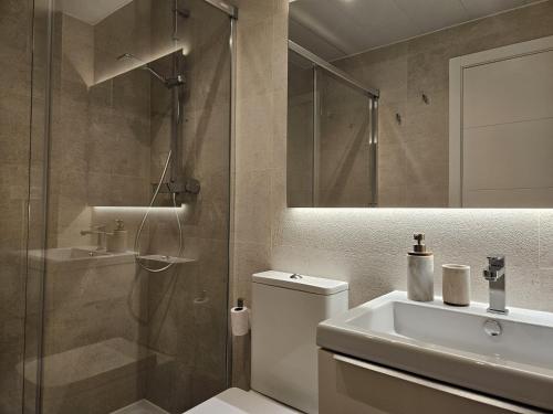 a bathroom with a shower and a toilet and a sink at Marina Serena in La Cala de Mijas