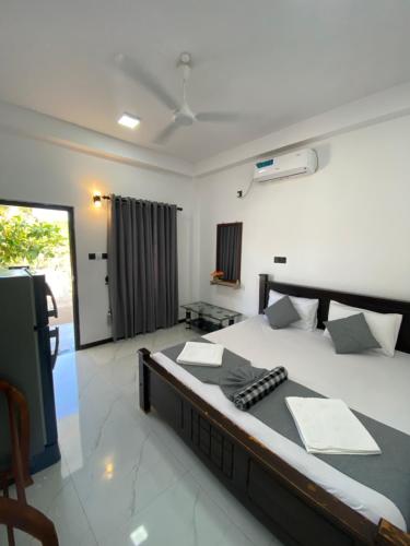 a bedroom with a large bed in a room at NRT Beach Hotel in Trincomalee