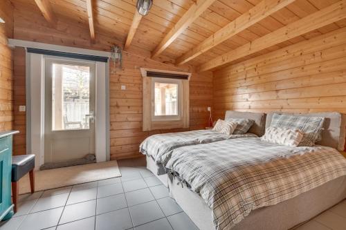 a bedroom with a bed in a wooden cabin at Green House in Koudekerke