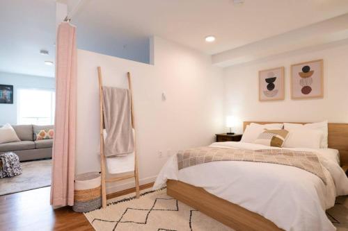 a bedroom with a bed and a living room at Stunning Capitol Hill 1BD Condo in Seattle