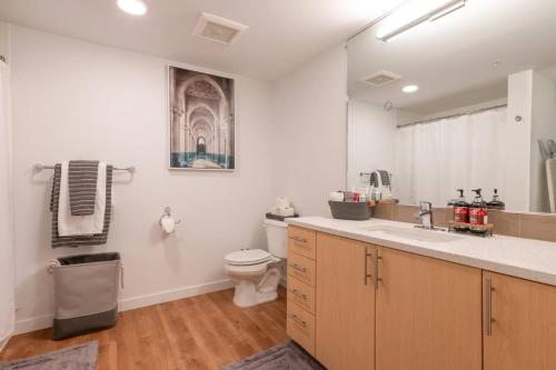 a bathroom with a sink and a toilet in it at Stunning Capitol Hill 1BD Condo in Seattle