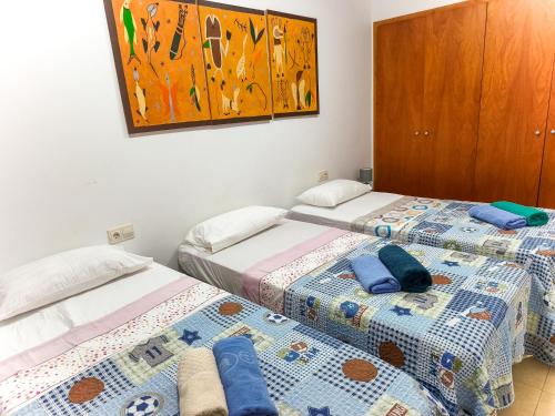 two beds sitting next to each other in a room at Boadella-Fenals in Lloret de Mar