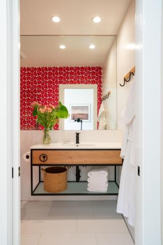 a bathroom with a sink and a red wall at Mendocino Cove in Fort Bragg