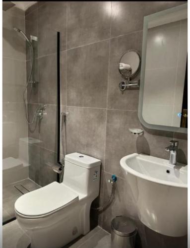 a bathroom with a toilet and a sink at شقة فندقية فاخرة in Taif