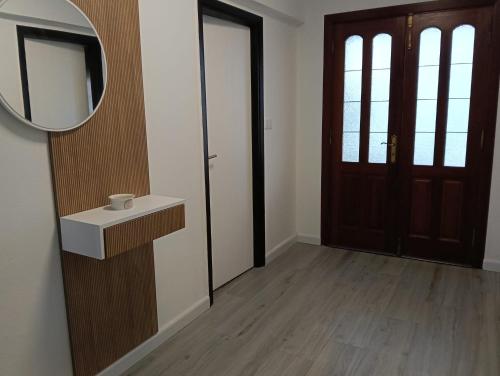 a bathroom with a mirror and a sink and a door at Casa Tamiván in Muxia