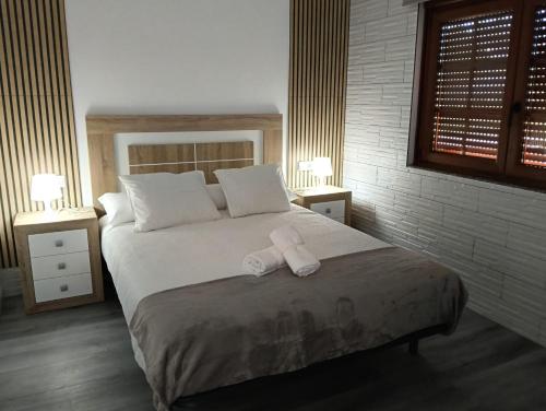 a bedroom with a bed with a towel on it at Casa Tamiván in Muxia