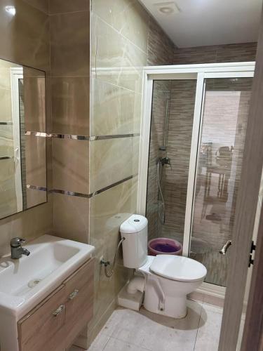 a bathroom with a toilet and a sink and a shower at Appart 5min plage, plein centre in Sidi Rahal