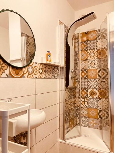 a bathroom with a shower and a sink and a mirror at Casa Di Luce Junior Con Parcheggio Privato in Montesilvano