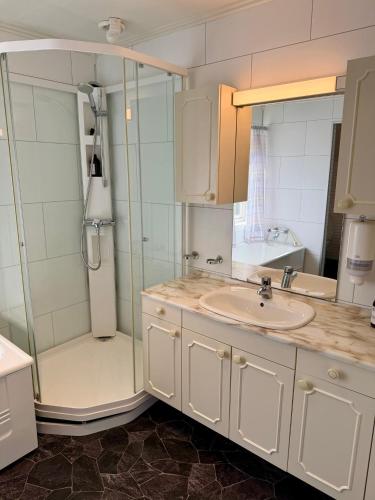 a bathroom with a sink and a shower at ROOMS by Ramberg Beach in Ramberg