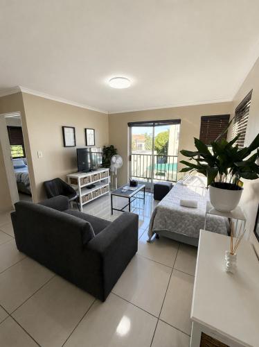 a living room with a couch and a bed at Unit 5 in Serengeti Complex, Bloemhof, Bellville in Blomtuin