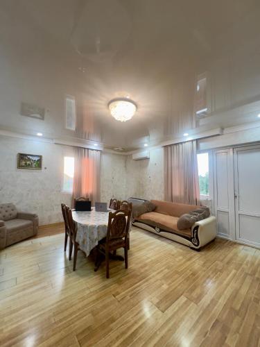 a living room with a table and a couch at Villa de Ureki in Ureki
