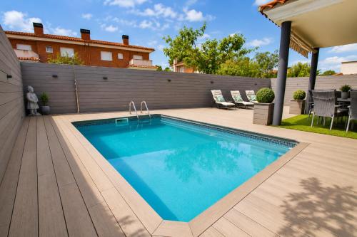 a swimming pool in a backyard with a house at Dream Planetcostadorada in Salou