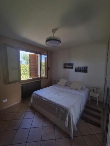 a bedroom with a large bed and a window at La Casina in Pontedera
