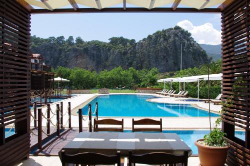 a view of a swimming pool from a resort patio at Aydos Suites in Dalyan