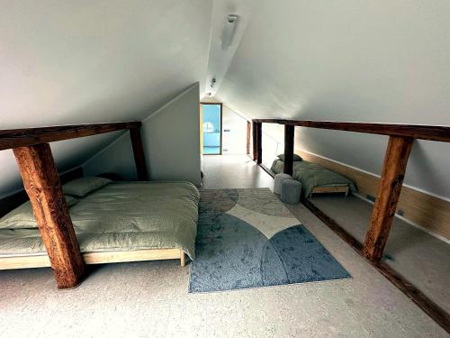 a bedroom with two bunk beds in a attic at Cathedral Apartment Tartu in Tartu