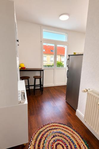 a living room with a table and a refrigerator at Pension zum Ziegenbart in Tangermünde