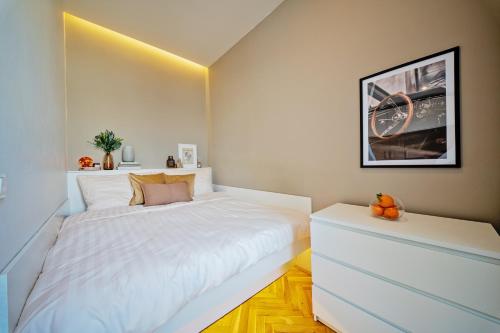 a white bedroom with a large white bed in it at Gem Stone City Center in Olomouc