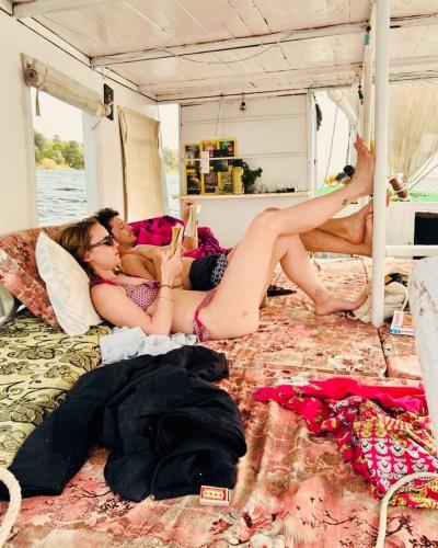 two women laying on a bed in a bus at faloka Farha Camp in Aswan