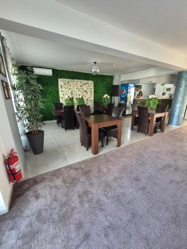 a dining room with a table and chairs at Vila Zara in Mamaia Sat/Năvodari
