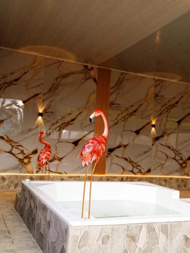 two flamingos standing on a white table in a room at CABAÑAS SANTA TERESA in Tibasosa