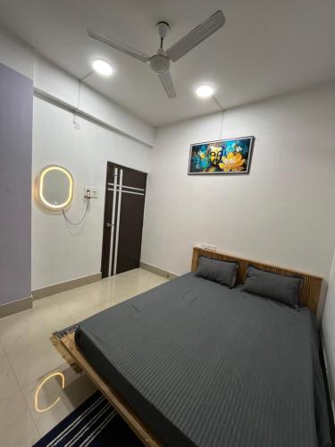 a bedroom with a bed and a ceiling fan at Pure Bliss 3BHK Stay in Guwahati