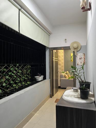 a living room with a table with plants on it at Pure Bliss 3BHK Stay in Guwahati