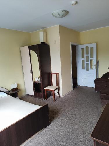 a bedroom with a bed and a chair and a couch at SunKiss in Melnragė