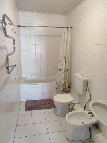 a bathroom with a toilet and a sink at SunKiss in Melnragė