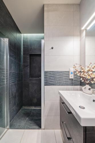 a bathroom with a shower and a sink at Gem Stone City Center in Olomouc