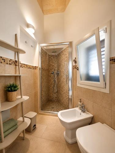 a bathroom with a shower and a toilet and a sink at Dimora IL TULIPANO BIANCO in Massafra