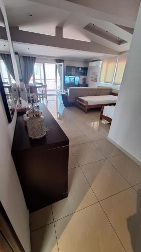 a living room with a couch and a table at revisapartments brown in Neos Marmaras