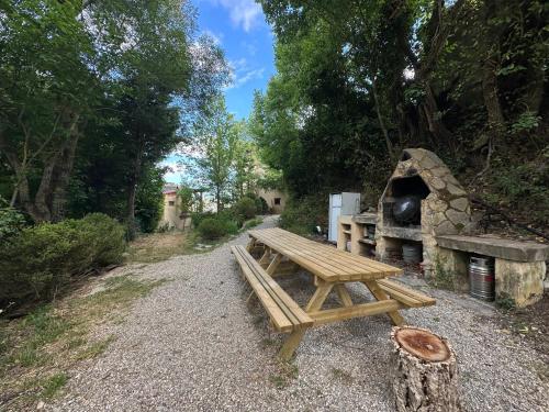 a picnic table and a stone oven in a park at Hogar del Sol in Pamplona
