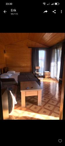 a room with two beds and a table in it at Syuzn Resort in Goris