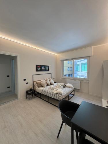 a bedroom with a bed and a table in it at Mono Chic by PortofinoVacanze in Rapallo