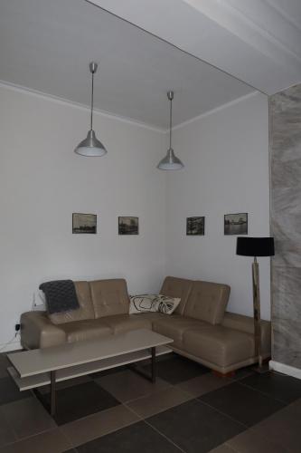 a living room with a couch and a table at Apartament Bankowy in Olecko