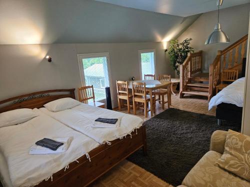 a bedroom with a bed and a table and chairs at Villa Gargano in Pieksämäki