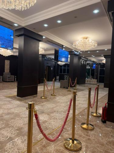 a lobby with red rope barriers in a room at غرفه سويت مع مطبخ in Buraydah