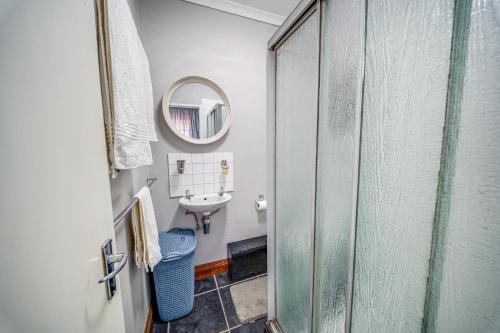 a bathroom with a sink and a mirror at 13 Hobson in Secunda