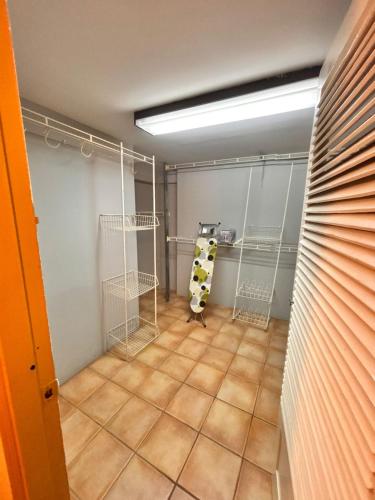 a walk in closet with swings and a tiled floor at Serenity Garden Escape in Port-of-Spain