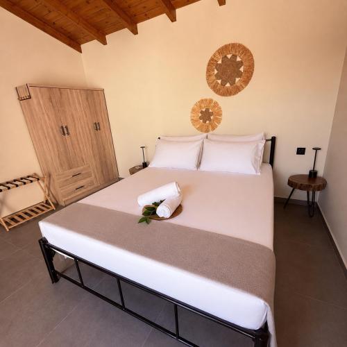 a bedroom with a large white bed with white pillows at LemonTreesHouses 1 Peaceful Stay Near Athens Airport & Rafina Port in Pikérmion