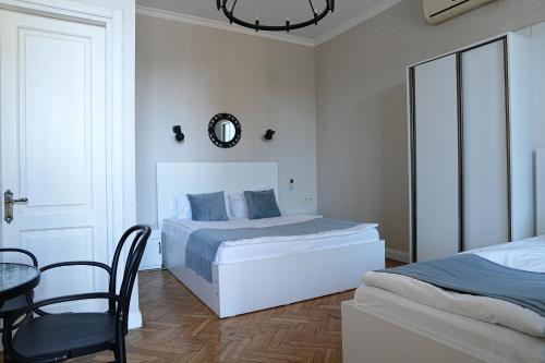 a bedroom with a bed and a table and a chair at Hotel Ticiani 15 in Kutaisi
